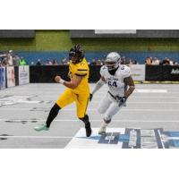 Tucson Sugar Skulls placekicker Diego Marquez is chased by a San Diego Strike Force defender