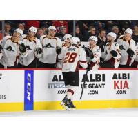 Cleveland Monsters center Zac Dalpe exchanges high fives with the bench