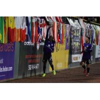 Louisville City FC forward Lucky Mkosana high fives fans