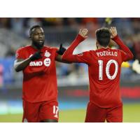 Toronto FC's Jozy Altidore (L) and Alejandro Pozuelo (R)