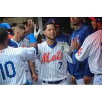 Gregor Blanco celebrates with his Syracuse Mets teammates in the dugout during Sunday's game
