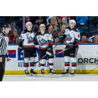 Kelowna Rockets forward Pavel Novak (centre) and defenceman Kaedan Korczak (right)