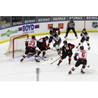 Kelowna Rockets try to control the puck in front of the Prince George Cougars net