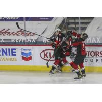 Vancouver Giants defenceman Nicco Camazzola (center) delivers a hit vs. the Prince George Cougars