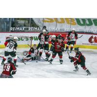 Vancouver Giants centre Tristen Nielsen (right) takes a shot vs. the Prince George Cougars