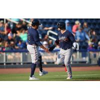 Jesse Franklin V of the Mississippi Braves receives congratulations as he rounds the bases