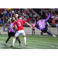 Atlético Ottawa's Luke Adam Singh and Cavalry FC's Callum Montgomery in action