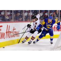 Saskatoon Blades left wing Misha Volotovskii (right) vs. the Calgary Hitmen