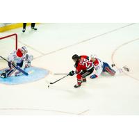 Kelowna Rockets' Andrew Cristall battles Spokane Chiefs' Cooper Michaluk and Berkly Catton