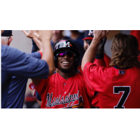 Geraldo Quintero of the Mississippi Braves receives congratulations in the dugout