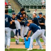 Rafael Flores is greeted by Somerset Patriots teammates after his game-winning home run