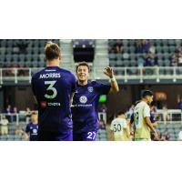 Louisville City FC defender Jake Morris greets midfielder Evan Davila