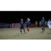 South Georgia Tormenta FC's Aaron Lombardi, Curtis Thorn, and Jake Dengler on the field