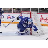 Syracuse Crunch goaltender Brandon Halverson dives for a loose puck