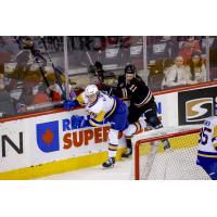Saskatoon Blades' Brayden Klimpke and Calgary Hitmen's Benjamin Kindel in action