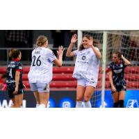 Racing Louisville FC midfielder Taylor Flint congratulates Emma Sears on her goal