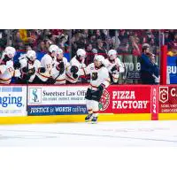 Vancouver Giants exchange congratulations along the bench